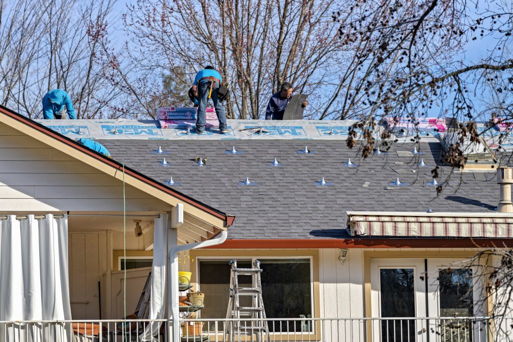 MEC Builds team on roof repair